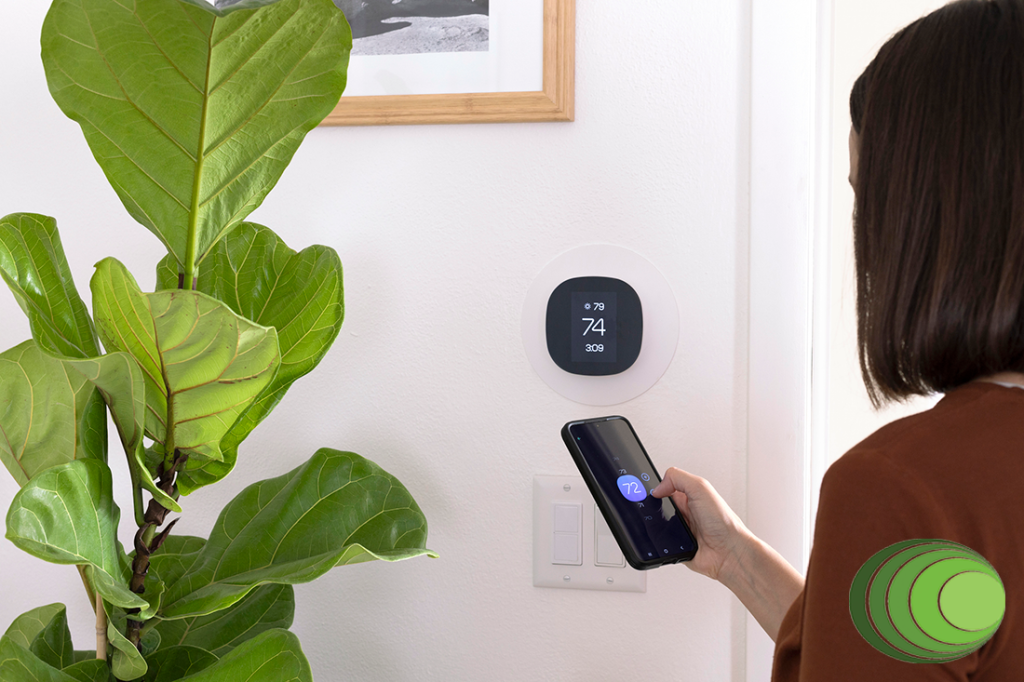 A woman using a smartphone to adjust the room temperature